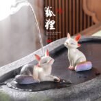 Two color-changing fox ceramic tea pets